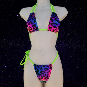 May include: A neon green and rainbow leopard print bikini with a halter top and a cheeky bottom.