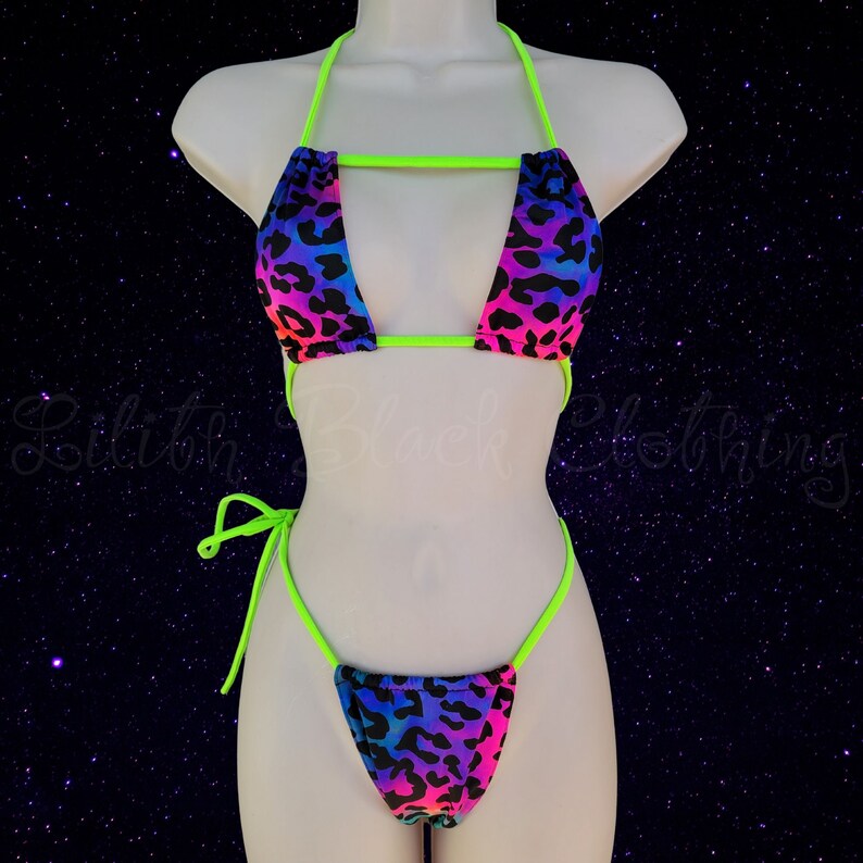 May include: A neon green and rainbow leopard print bikini with a halter top and a string bottom.