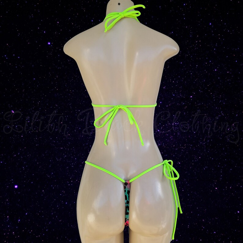 May include: A neon green bikini with a colorful patterned bottom. The bikini top has adjustable straps and ties at the back. The bikini bottom has a string tie on each side.