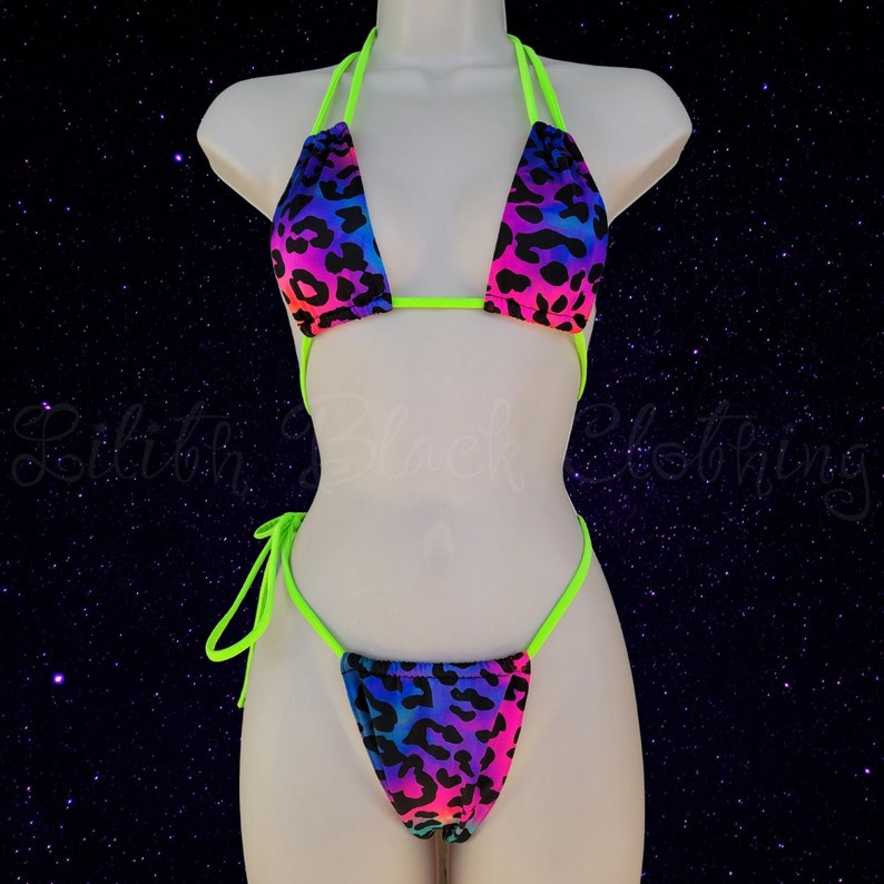 May include: A neon green and rainbow leopard print bikini with a halter top and a cheeky bottom.