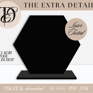 May include: A black, hexagonal display stand with a rectangular base. The text "THE EXTRA DETAIL" is at the top. The image includes the text "FREE KERF TOOL INCLUDED!" and "Laser Tested". The bottom of the image says "DIGITAL download AI SVG PDF DXF".