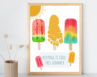 May include: A framed print featuring watercolor illustrations of popsicles in various colors: watermelon, yellow, and rainbow. The text "KEEPING IT COOL THIS SUMMER" is included. The sun is depicted in the upper left corner.