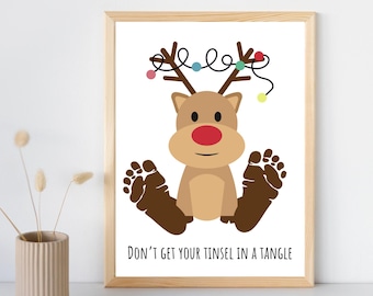 May include: A framed print featuring a cartoon reindeer with a red nose, brown antlers, and brown footprints. The reindeer has a string of colorful lights above its head. The text "DON'T GET YOUR TINSEL IN A TANGLE" is below the reindeer.