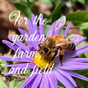 May include: A bee pollinating a purple flower with the text "For the garden, farm, and field" written in white cursive.