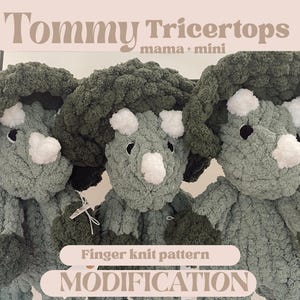 May include: Three crocheted stuffed triceratops toys in green and white. The toys are labelled "Tommy Triceratops mama + mini" and "Finger knit pattern MODIFICATION".