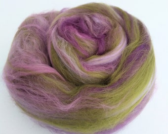 May include: A bundle of colorful wool roving in shades of green, pink, and white. The roving is soft and fluffy, perfect for spinning or felting.