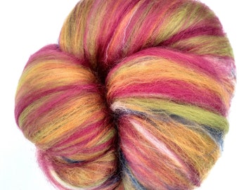 May include: A ball of colorful wool yarn in shades of red, orange, yellow, green, and blue. The yarn is arranged in a loose, fluffy pile.