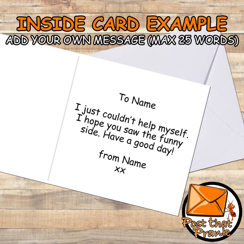 May include: A white greeting card with a sample message inside, presented with a white envelope. The text on the card reads "To Name, I just couldn't help myself. I hope you saw the funny side. Have a good day! from Name xx." The card is on a wooden surface.