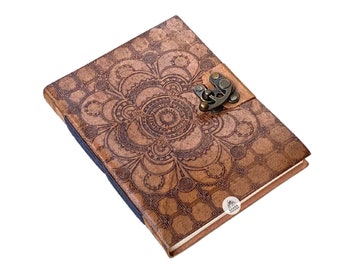 May include: A brown leather journal with a mandala design and a metal clasp. The journal has a blue ribbon bookmark.