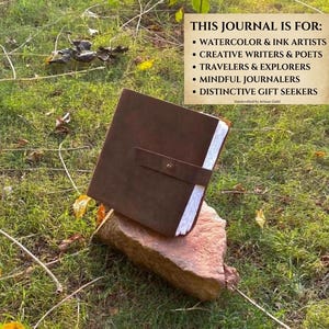 May include: A dark brown leather journal with a strap closure and white pages. The text reads: THIS JOURNAL IS FOR: WATERCOLOR & INK ARTISTS, CREATIVE WRITERS & POETS, TRAVELERS & EXPLORERS, MINDFUL JOURNALERS, DISTINCTIVE GIFT SEEKERS.