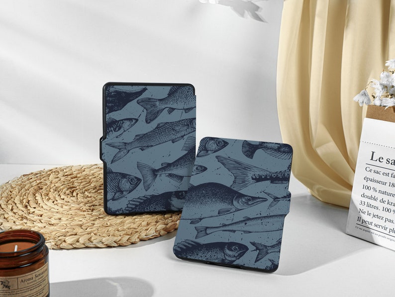 May include: Two blue and black e-reader cases with a fish pattern. The cases are made of a soft, durable material and have a sleek, modern design.