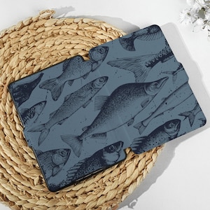 May include: A blue and white patterned case for an e-reader, featuring a design of various fish illustrations.