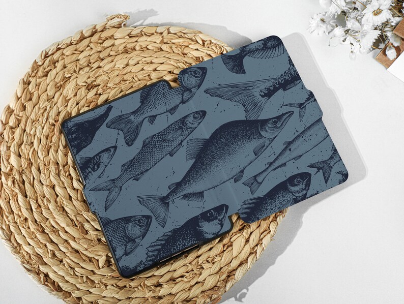 May include: A blue and white patterned case for an e-reader, featuring a design of various fish illustrations.