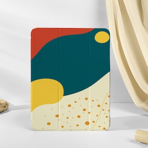 Könnte beinhalten: Eine iPad-Hülle mit einem farbenfrohen abstrakten Design in Türkis, Gelb, Rot und Weiß. Die Hülle hat ein geometrisches Design mit abgerundeten Kanten.