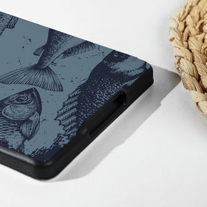 May include: A blue phone case with a black border and a pattern of black and white fish illustrations.