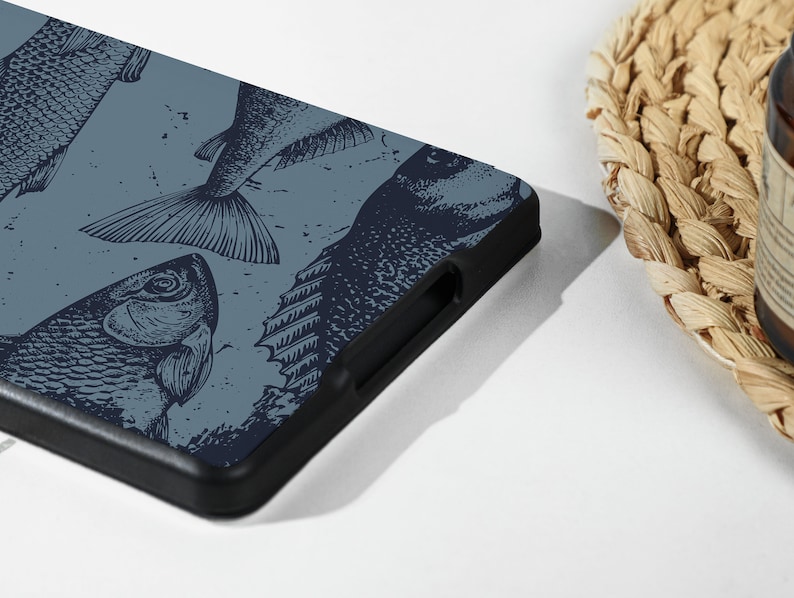 May include: A blue phone case with a black border and a pattern of black and white fish illustrations.