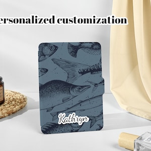 May include: A blue phone case with a personalized name, "Kathryn", and a vintage illustration of fish.