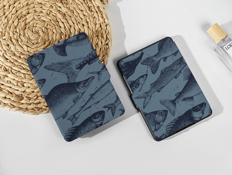 May include: Two blue e-reader covers with a pattern of black fish silhouettes.