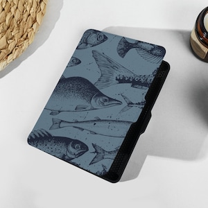 May include: A blue and black e-reader cover with a pattern of fish illustrations.