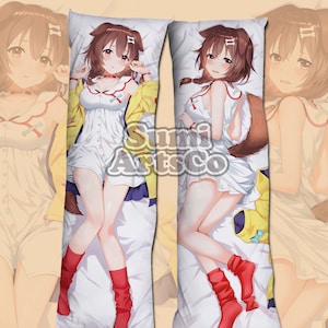 May include: A long body pillow featuring an anime character with brown hair, wearing a white dress with a yellow jacket and red socks. The character has a fox tail and ears.
