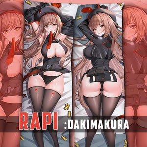 May include: A long body pillow featuring an anime character with long brown hair, wearing a black and red outfit with a red star on the thigh. The pillow has the text "RAPI : DAKIMAKURA" printed on the bottom.