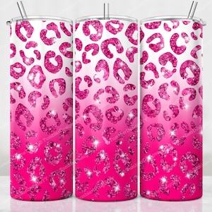 May include: Three stainless steel tumblers with a pink leopard print design. The design features a gradient from white to bright pink, with sparkling glitter accents. Each tumbler has a silver straw.