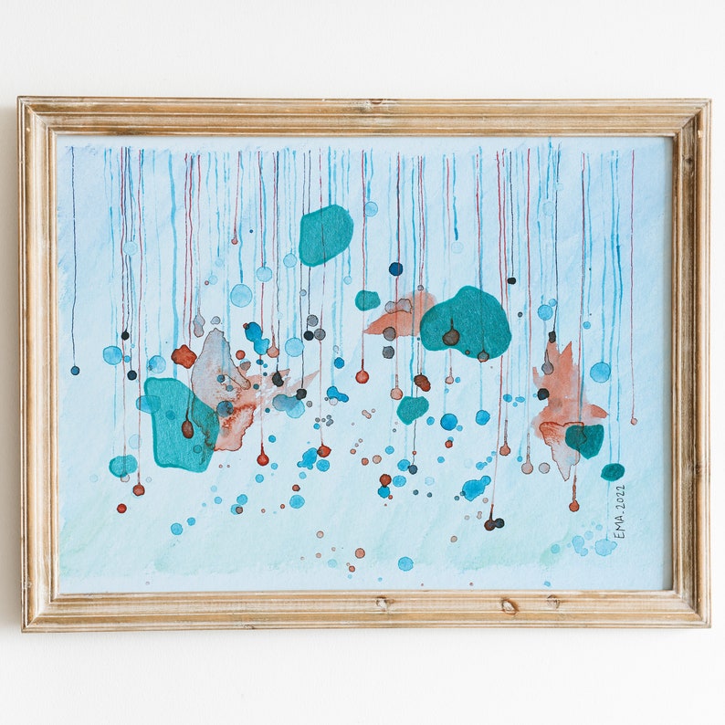 My handmade unique abstract mixed media work called Rain. Blue, metallized green and orange shades like rain drops. Placed in a golden mockup frame on a white background.