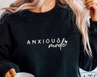 May include: Black sweatshirt with white text that reads "ANXIOUS mode" with a small heart symbol.