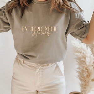 May include: A gray t-shirt with the text "ENTREPRENEUR Mentality" printed on the front.