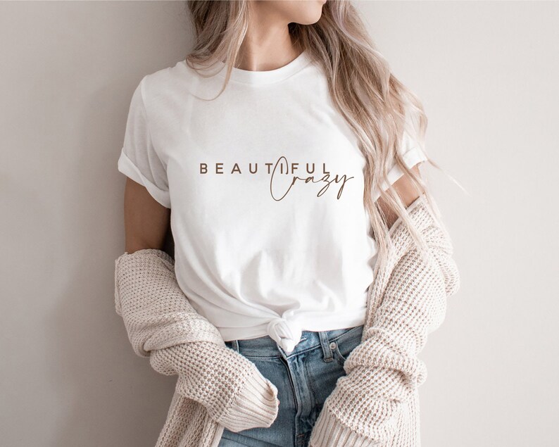 May include: White t-shirt with the text "BEAUTIFUL crazy" printed in brown on the front.