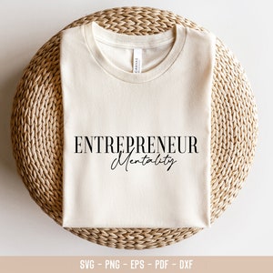 May include: A beige t-shirt with the text "ENTREPRENEUR Mentality" printed in black.