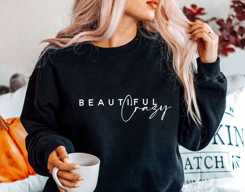 May include: Black sweatshirt with white text that reads "Beautiful Crazy".