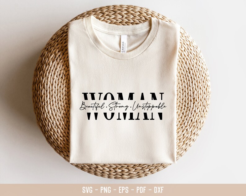 May include: A white t-shirt with the text "WOMAN Beautiful. Strong. Unstoppable WOMAN" in black lettering.
