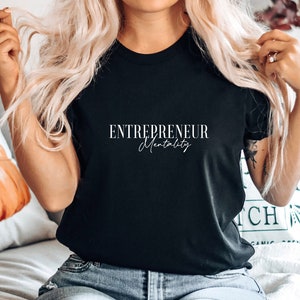 May include: Black t-shirt with white text that reads "ENTREPRENEUR Mentality".