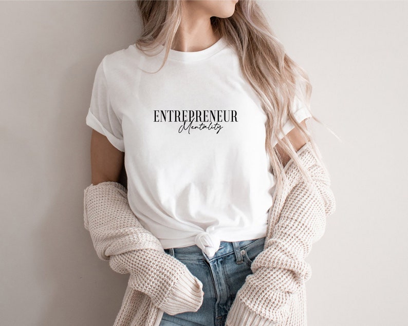 May include: White t-shirt with the text "ENTREPRENEUR Mentality" in black lettering.