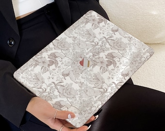 May include: A white laptop skin with a floral pattern in shades of gray. The skin is designed to fit a standard laptop.