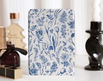 May include: A white background with a blue floral pattern. The pattern includes tulips, ferns, and other flowers. The design is reminiscent of vintage botanical illustrations.