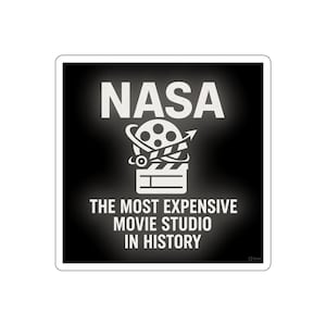 May include: A square sticker with a black background and white text. The word "NASA" is at the top, above a graphic of a film reel and clapperboard. Below the graphic is the text "THE MOST EXPENSIVE MOVIE STUDIO IN HISTORY."