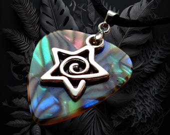 May include: A guitar pick pendant featuring an iridescent abalone shell surface with a silver-toned metal star charm centered on the front. The star charm has a spiral design in its middle and is attached to a black cord necklace by a silver bail.