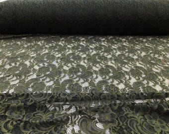 May include: Olive green lace fabric with a floral pattern. The lace is delicate and has a soft, flowing texture.