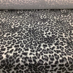 May include: Gray and black fabric with a leopard print pattern.