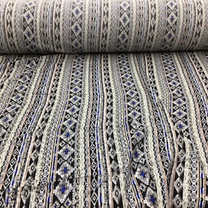 May include: Black and white fabric with a geometric pattern in shades of blue and pink. The fabric has a vertical stripe design.