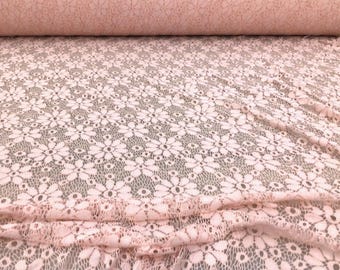 May include: Pink floral lace fabric with a delicate pattern. The lace is soft and sheer, making it perfect for a variety of projects.