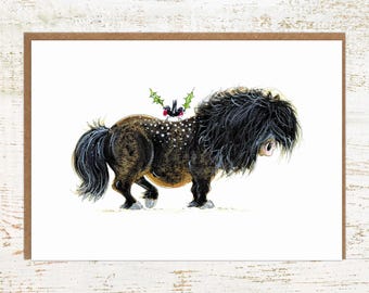 May include: A black and brown pony with a long, shaggy mane and tail. Two small birds with red berries are perched on its back, surrounded by green holly leaves.