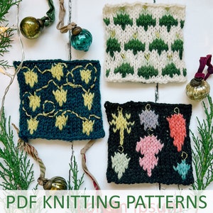 May include: Four knitted Christmas ornament squares with different designs. The squares are on a white wooden surface with Christmas lights and baubles. The designs include a string of lights, a Christmas tree, and a snowflake.