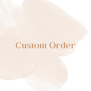May include: A graphic design featuring the text Custom Order in a serif font, centred over a background of overlapping, semi-transparent brushstrokes in a soft, pale cream colour, creating a layered and textured visual effect.