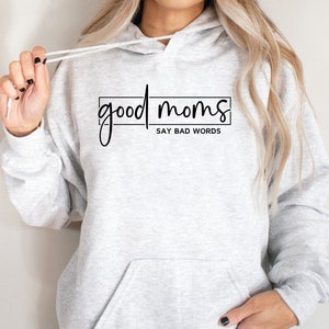May include: Gray hooded sweatshirt with the text "good moms say bad words" printed on the front.