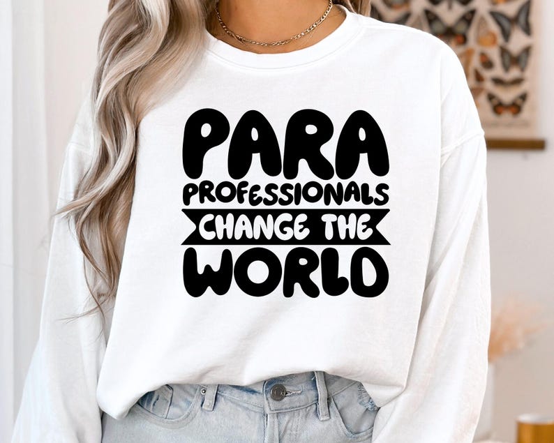 May include: White long-sleeved shirt with black text that reads "Para Professionals Change The World".
