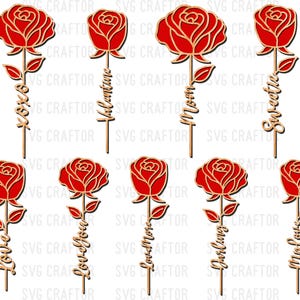 May include: A collection of red rose-shaped wooden cutouts with gold outlines. Each rose is attached to a stem with leaves and a word, including "XOXO", "Valentine", "Mom", "Sweetie", "Love", "Love You", "Darling", and "My Love".