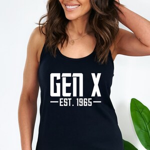 May include: Black tank top with white text that reads "GEN X - EST. 1965 -"